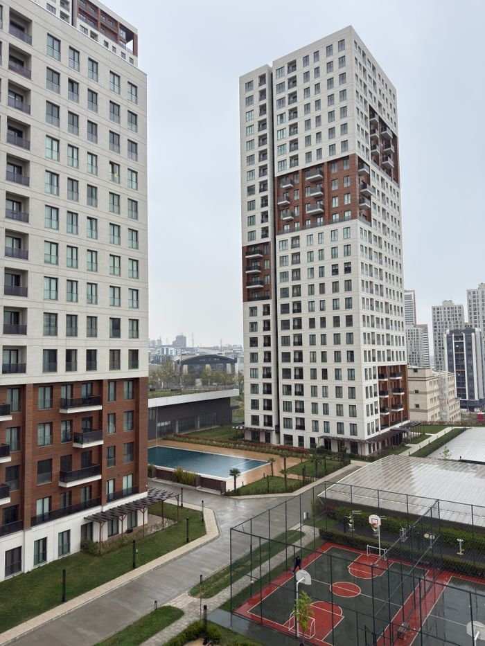 gallery-2 Modern high-rise buildings with basketball courts and pool in urban residential area.